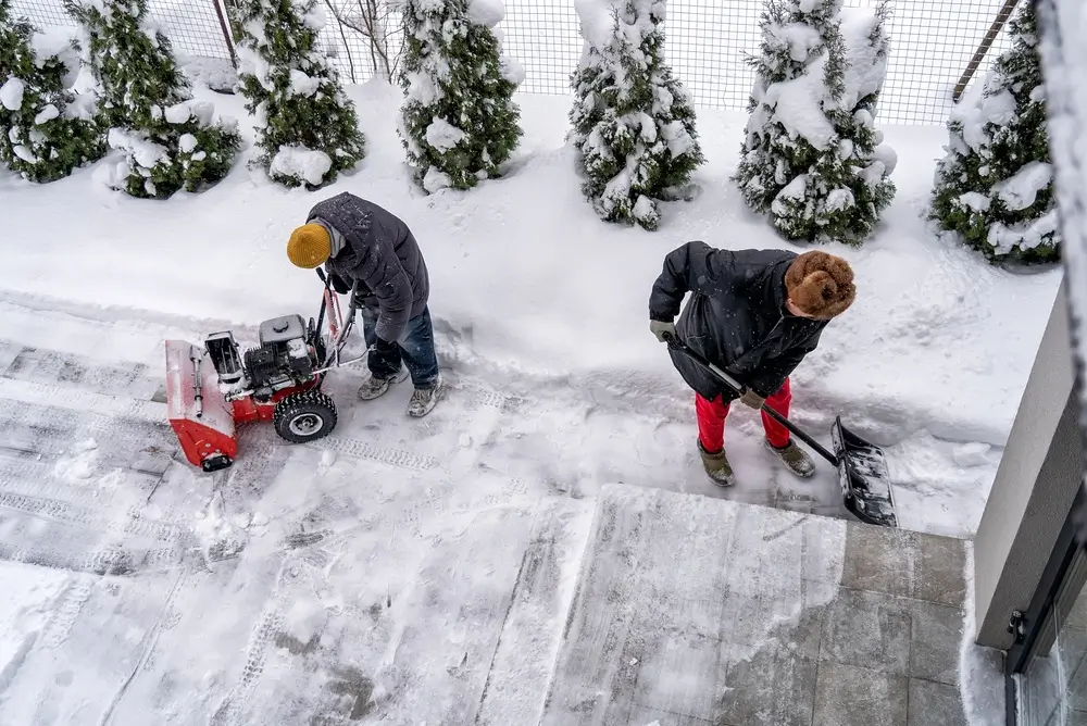 Snow removal from a concrete driveway to protect the surface during Colorado winter