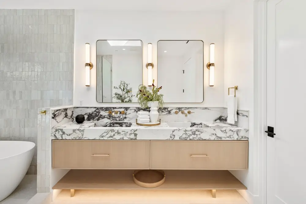 Modern Lakewood bathroom with layered vanity lighting and illuminated mirrors