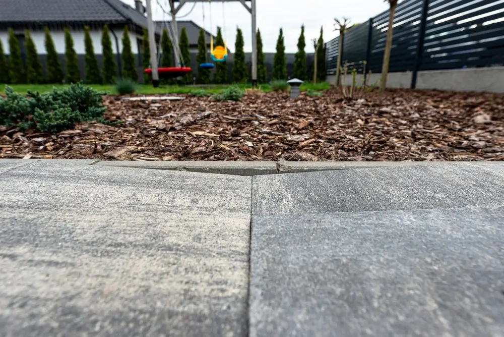 Damaged concrete driveway prepared for replacement with removed broken concrete sections